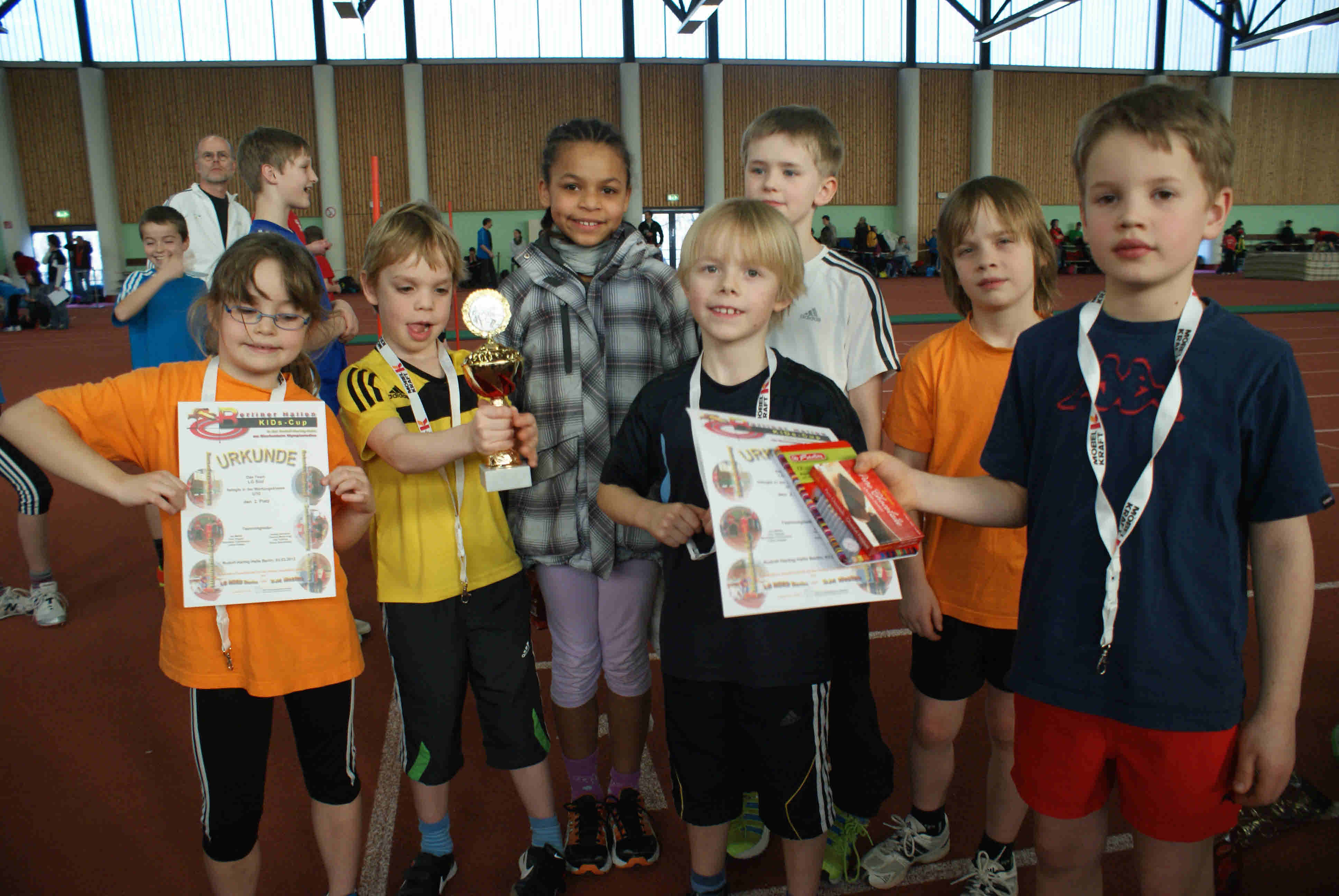 Kinder mit Urkunden, Preisen und Pokal